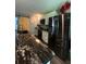 Kitchen featuring marble countertops, white cabinetry, stainless steel appliances and barn door access at 3339 Croton Ave, Deltona, FL 32738