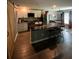 Open-concept kitchen featuring a marble island, modern appliances, white cabinetry and barn door access at 3339 Croton Ave, Deltona, FL 32738
