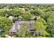 Aerial view of a property showcasing lush landscaping, a tile roof, and a beautiful neighborhood at 3988 Radley Ct, Longwood, FL 32779