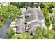 Aerial image of homes with tile roofs, green landscaping, and private patios in a lush community at 3988 Radley Ct, Longwood, FL 32779