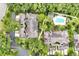 Lush, mature landscaping surrounds charming townhomes with a refreshing community pool for relaxation at 3988 Radley Ct, Longwood, FL 32779