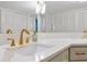 Bright bathroom features dual sinks with marble countertops, gold hardware, and ample storage space at 3988 Radley Ct, Longwood, FL 32779