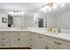 Bright bathroom features dual sinks with marble countertops, gold hardware, and ample storage space at 3988 Radley Ct, Longwood, FL 32779