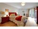 Bright bedroom featuring a cherry wood bed frame, complemented by a cozy blanket and outdoor access at 3988 Radley Ct, Longwood, FL 32779