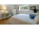 Bright bedroom featuring a work space, white bedding and a window overlooking the outdoor landscape at 3988 Radley Ct, Longwood, FL 32779