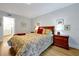 Inviting bedroom with warm cherry wood furniture, soft duvet, and calming decor for relaxation at 3988 Radley Ct, Longwood, FL 32779