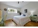 Bright bedroom featuring a bed with decorative pillows, a window with shutters, and stylish side tables at 3988 Radley Ct, Longwood, FL 32779