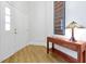 Inviting entryway featuring beautiful hardwood floors, a console table, and a stylish lamp creating a warm and welcoming ambiance at 3988 Radley Ct, Longwood, FL 32779