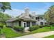 Rear exterior view of home featuring a screened porch, lush landscaping, and a private outdoor space at 3988 Radley Ct, Longwood, FL 32779