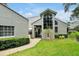 Charming home featuring a landscaped yard and stucco exterior, with an arched window and lovely curb appeal at 3988 Radley Ct, Longwood, FL 32779