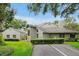 Charming home featuring a landscaped yard and stucco exterior, with a green lawn and mature trees at 3988 Radley Ct, Longwood, FL 32779