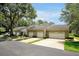 Exterior view of this home with an attached garage, green grass and beautiful landscape at 3988 Radley Ct, Longwood, FL 32779