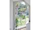 Bright foyer boasts a large arched window offering scenic views, accented by an elegant pendant light fixture at 3988 Radley Ct, Longwood, FL 32779