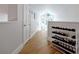 Hallway with a wine rack, a door and an arched window at the end showing the outside view at 3988 Radley Ct, Longwood, FL 32779
