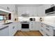 Stylish kitchen boasting white cabinets, modern appliances, quartz countertops, and sleek hardware creating a contemporary aesthetic at 3988 Radley Ct, Longwood, FL 32779