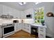 Bright kitchen featuring white cabinetry, modern appliances, and a window with a view, perfect for cooking and entertaining at 3988 Radley Ct, Longwood, FL 32779