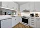 Charming kitchen showcasing white cabinetry, stainless steel appliances, and granite countertops offering functionality and style at 3988 Radley Ct, Longwood, FL 32779