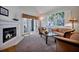 Comfortable living room with a fireplace, plush furniture, and large windows offering plenty of natural light and a serene view at 3988 Radley Ct, Longwood, FL 32779