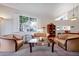 Open living room with a vaulted ceiling, comfortable furniture, and large windows providing a bright and airy atmosphere at 3988 Radley Ct, Longwood, FL 32779