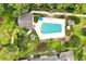 Overhead view of a refreshing pool surrounded by tropical landscaping and community spaces at 3988 Radley Ct, Longwood, FL 32779
