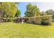 Expansive backyard showcases lush green lawn and mature trees, offering a peaceful setting for outdoor activities at 442 Dorothy Ave, Daytona Beach, FL 32117