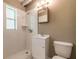 Modest bathroom features white tile shower with a small vanity and a matching framed mirror, offering essential functionality at 442 Dorothy Ave, Daytona Beach, FL 32117