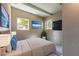 Bright bedroom boasts beamed ceilings, two windows, and a serene ambiance with a faux view, perfect for relaxation at 442 Dorothy Ave, Daytona Beach, FL 32117