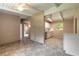 Open-concept space with neutral paint, and access to the adjacent kitchen with white cabinets at 442 Dorothy Ave, Daytona Beach, FL 32117