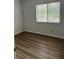 A clean bedroom with wood-look floors and a window at 79 Cypress Pond Rd # 79, Port Orange, FL 32128