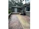 View of the home's exterior, showcasing the entrance, walkway, and landscaping at 79 Cypress Pond Rd # 79, Port Orange, FL 32128
