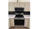Kitchen boasting new stainless steel oven and microwave above, with cream colored cabinets at 79 Cypress Pond Rd # 79, Port Orange, FL 32128