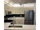 Well-equipped kitchen with stainless steel appliances and sleek black backsplash at 79 Cypress Pond Rd # 79, Port Orange, FL 32128