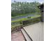 Cozy porch featuring a wooden railing and a view of the green landscape at 79 Cypress Pond Rd # 79, Port Orange, FL 32128