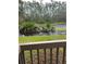 Outdoor view of backyard water feature surrounded by tall trees and lush green grass at 79 Cypress Pond Rd # 79, Port Orange, FL 32128
