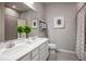 Bathroom with double vanity, large mirror, and shower at 2175 Aibonito Cir, Clermont, FL 34711