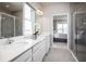 Bathroom with double vanity, shower, and bedroom view at 2175 Aibonito Cir, Clermont, FL 34711
