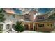 Two-story house with an outdoor sitting area and green trees at 4920 Sw 78Th Ave, Bushnell, FL 33513