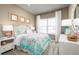 Charming bedroom with a floral bedspread and plenty of natural light at 746 Copper Creek Dr, New Smyrna Beach, FL 32168