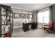 Functional home office featuring a large desk, bookshelves, and a leather armchair at 746 Copper Creek Dr, New Smyrna Beach, FL 32168