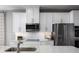 Modern kitchen with white cabinets, stainless steel appliances, and white countertops at 746 Copper Creek Dr, New Smyrna Beach, FL 32168