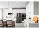 Modern kitchen with white cabinets, stainless steel appliances, and a large island at 746 Copper Creek Dr, New Smyrna Beach, FL 32168