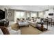 Open living room featuring neutral colors, plush sofas, and a large TV at 746 Copper Creek Dr, New Smyrna Beach, FL 32168