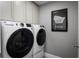 Convenient laundry room with washer, dryer, and gray walls at 286 Prickly Pear Ct, Lady Lake, FL 32159