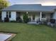 Large backyard with a covered patio and well-manicured lawn at 2719 Brookline Ave, New Smyrna Beach, FL 32168