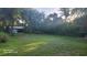 Large backyard with mature trees and metal storage structure at 2719 Brookline Ave, New Smyrna Beach, FL 32168