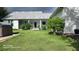 Backyard featuring a covered patio and lush lawn at 2719 Brookline Ave, New Smyrna Beach, FL 32168