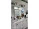 Bathroom featuring a double vanity with modern fixtures and a walk-in shower at 2719 Brookline Ave, New Smyrna Beach, FL 32168