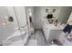 Bright bathroom featuring a walk-in shower with white tiles and dual sink vanity with light wood floors at 2719 Brookline Ave, New Smyrna Beach, FL 32168