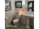 Cozy half bath features a pedestal sink, toilet, and neutral wall paint with decorative art at 2719 Brookline Ave, New Smyrna Beach, FL 32168