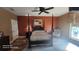 Comfortable bedroom with four-poster bed, a ceiling fan, and view of the backyard at 2719 Brookline Ave, New Smyrna Beach, FL 32168